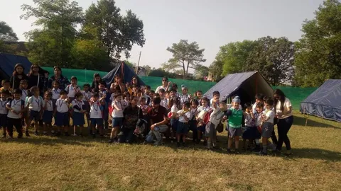 Students cheering outside their camp tents