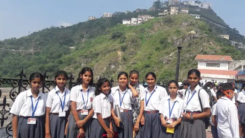 A school group posing at a hillside viewpoint
